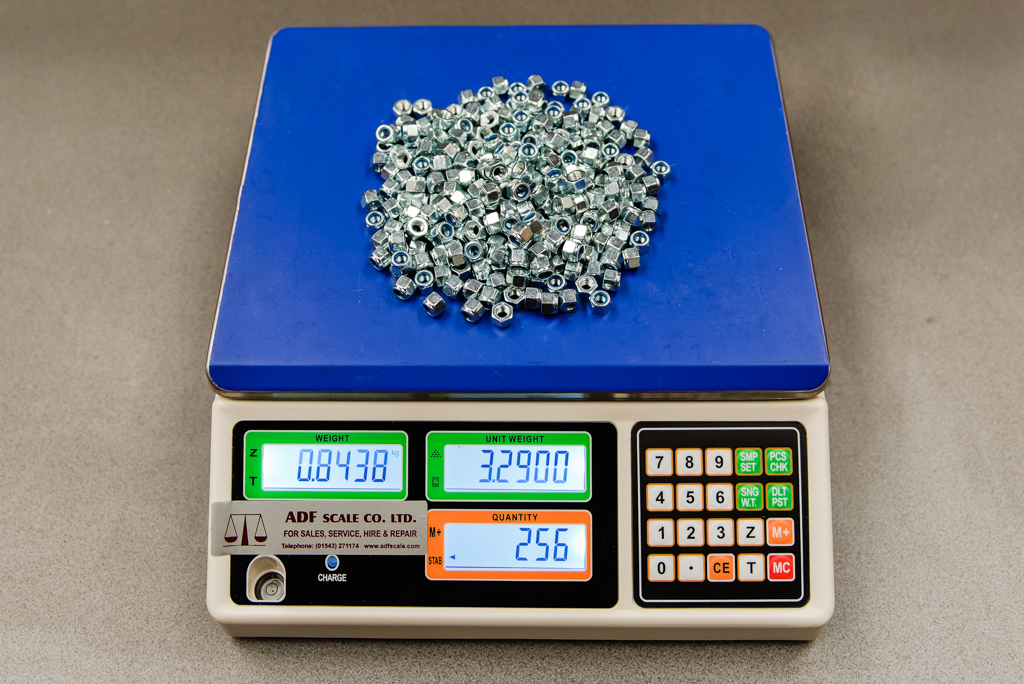Blue Digital weighing counting scale with nuts on the plate