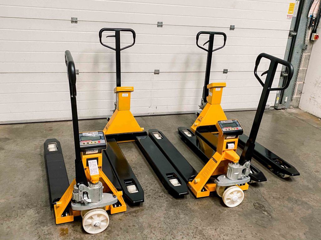 Workshop showing a bespoke weighing scale system with black and yellow pallet truck scales with printers connected to them