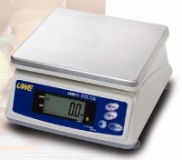 White and silver bench scale with stainless steel plate on a white and beige background