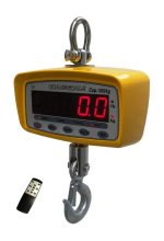 Large yellow and silver hanging scale with a digital display on a white background