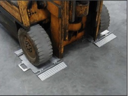 Low profile axel weigh pads with a forklift truck on them