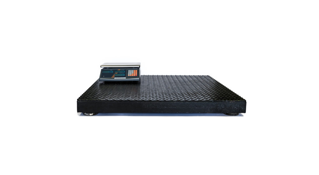 Large platform scale with a counting scale on top of it sitting on a white background