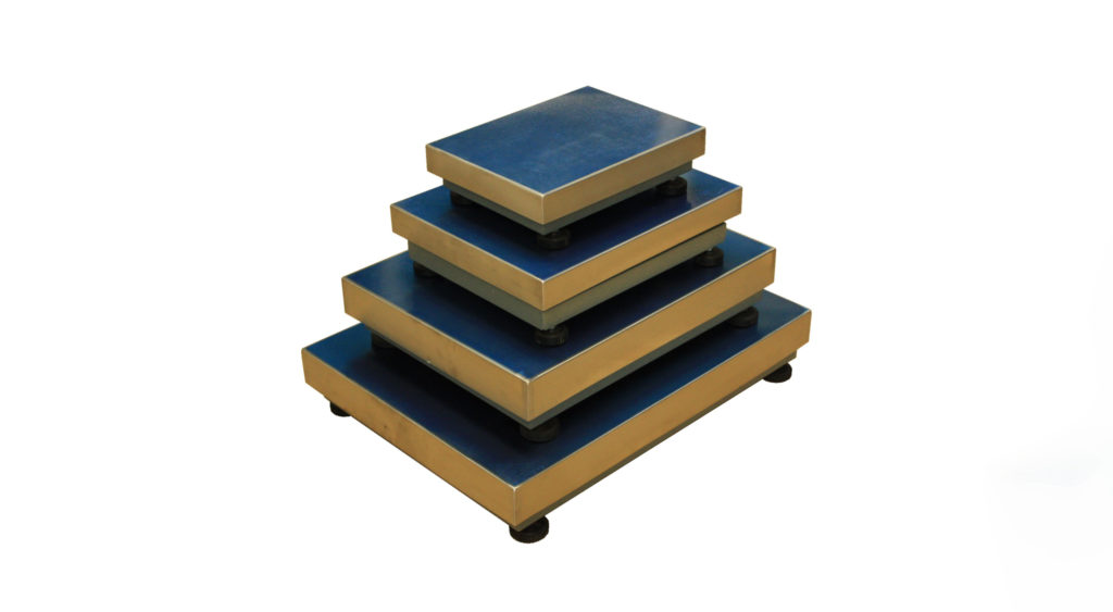 A stack of single load cell bases sitting on a white background
