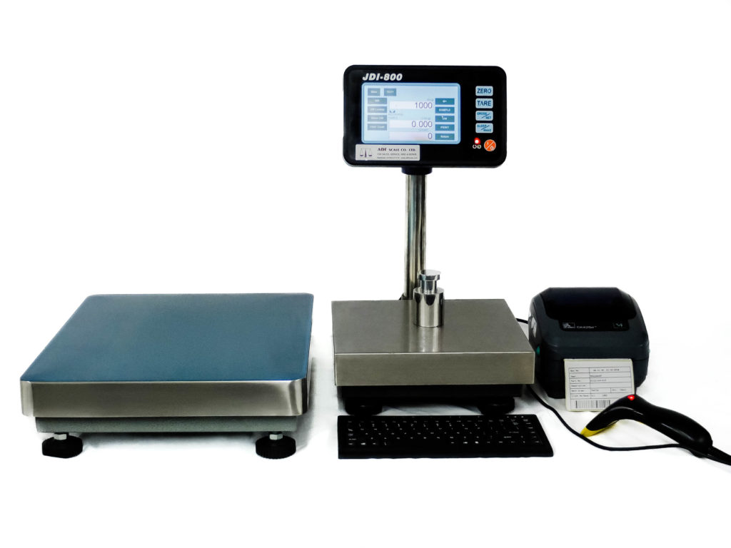 Digital weighing scale with platform and printer on a white background