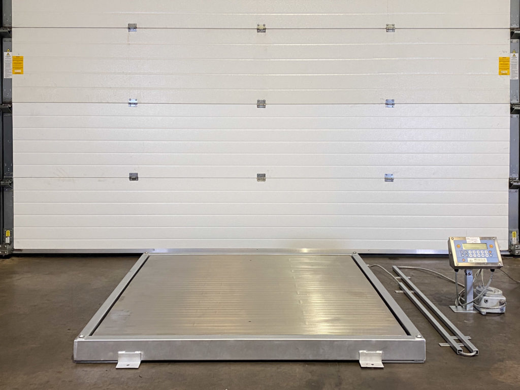 heavy-duty protective frame for platform weighing scale shown in front of some white workshop shutters