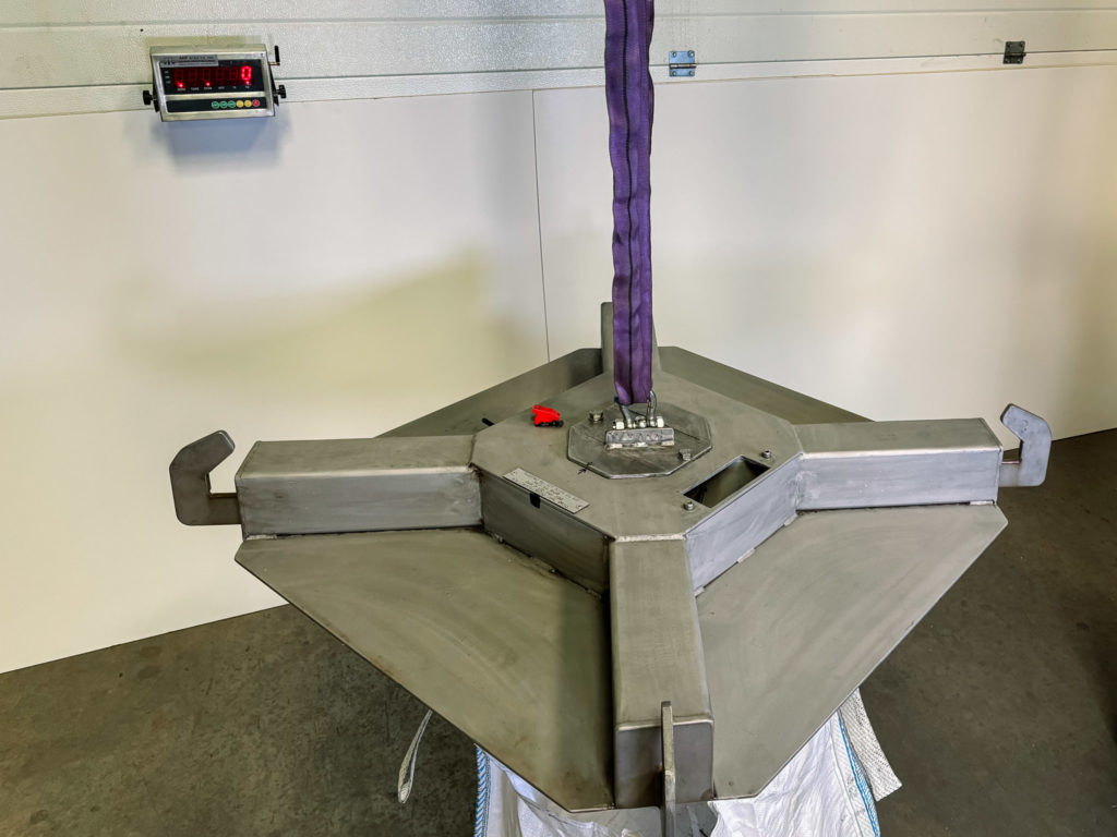 Image showing bespoke weighing solution of a cross weighing being suspended and the digital display in the background